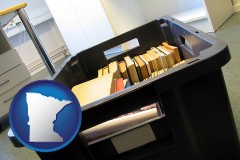 minnesota map icon and a moving box in an empty office, during a relocation project